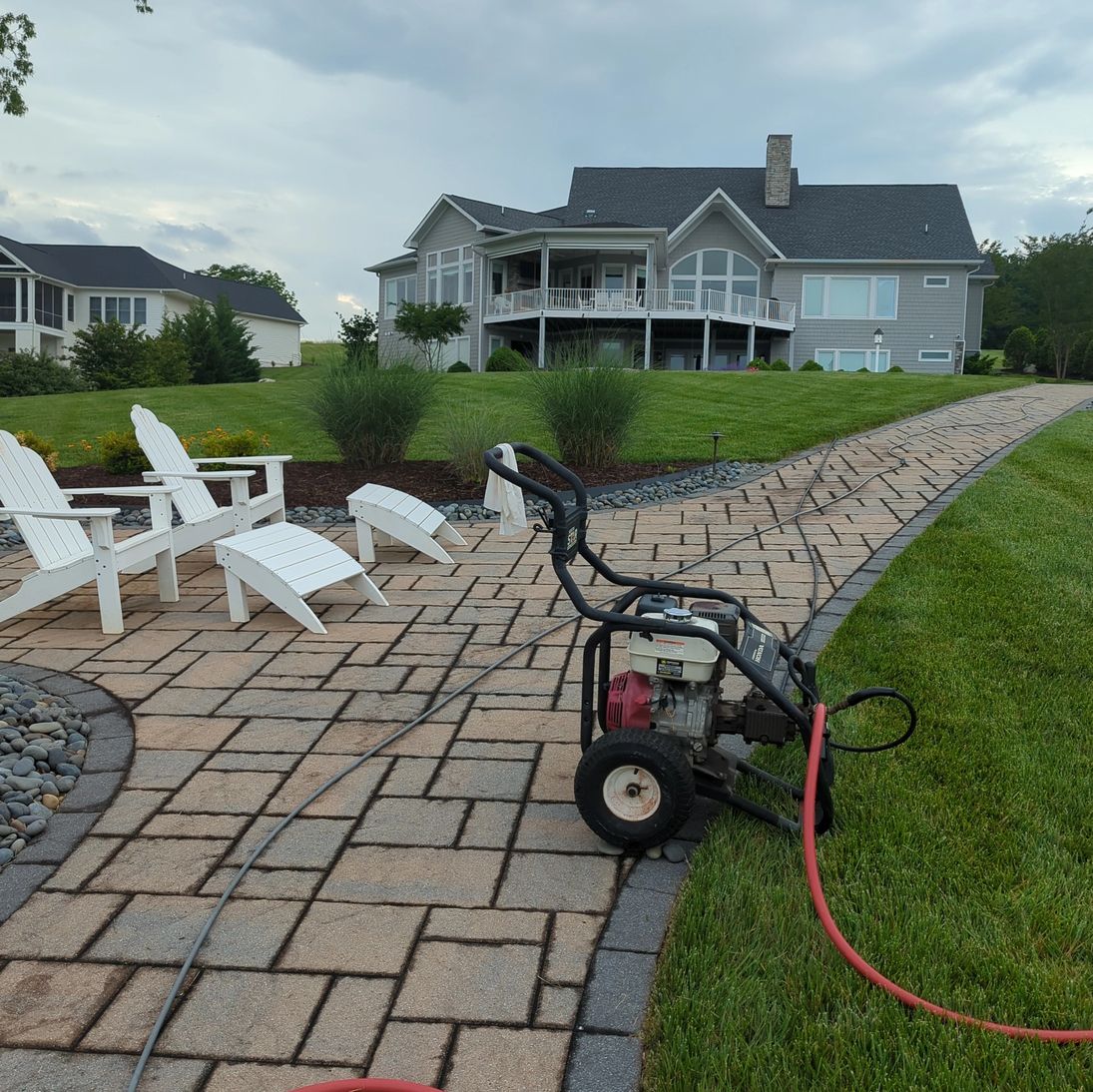 Pressure washing equipment staged beside a Smith Mountain Lake home and patio