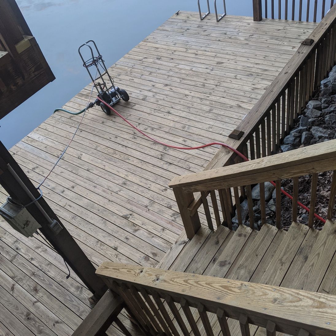 Industrial pump setup feeding water to a lakefront dock cleaning project